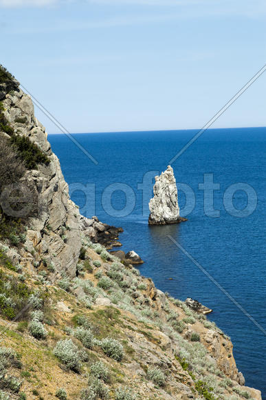 Mountains by the sea in beams of a bright sun