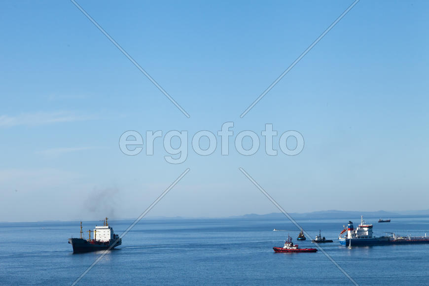 Seascape with ships and mountains on the horizon a bright sunny day