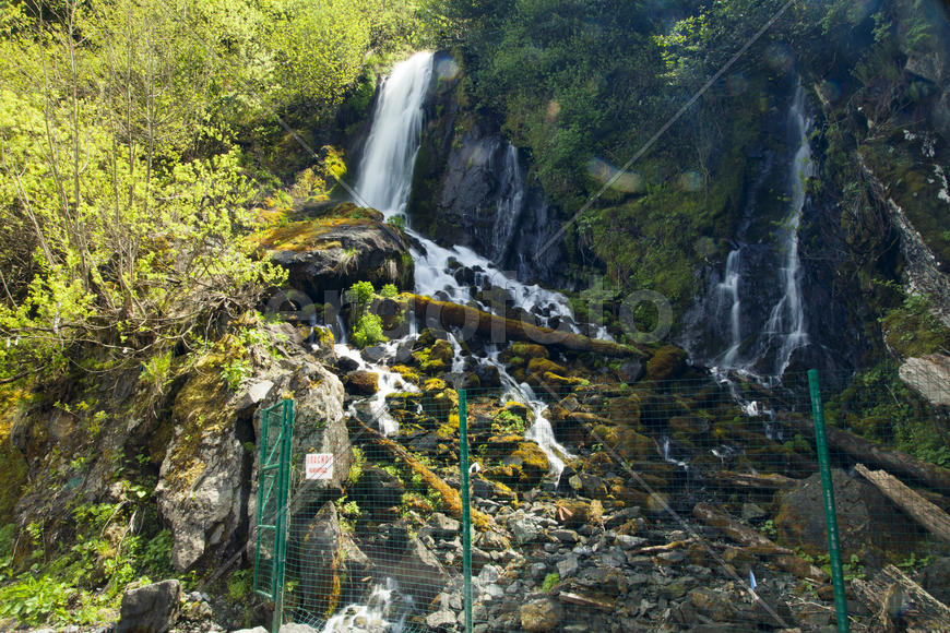 The falls in mountains flow from above and rustle