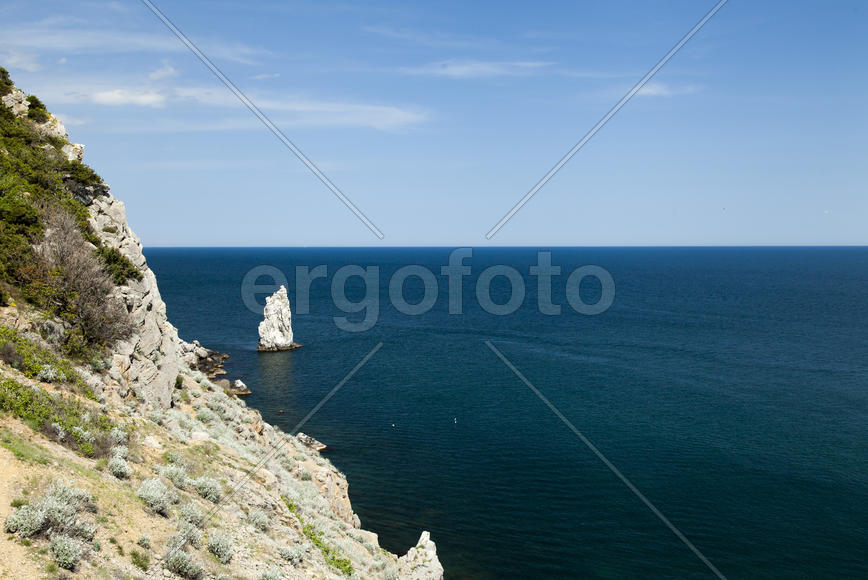 Mountains by the sea in beams of a bright sun