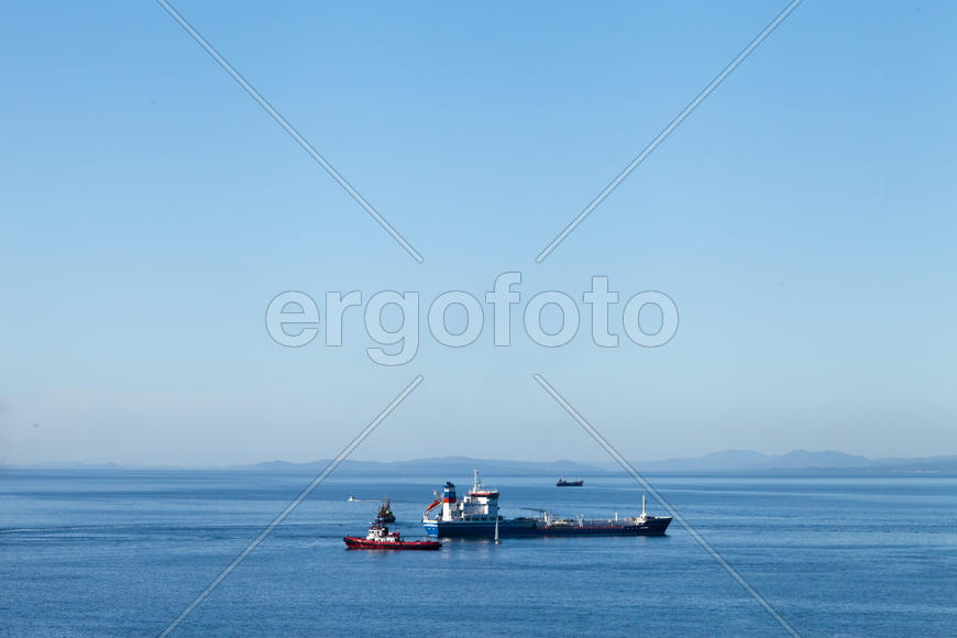 Seascape with ships and mountains on the horizon a bright sunny day