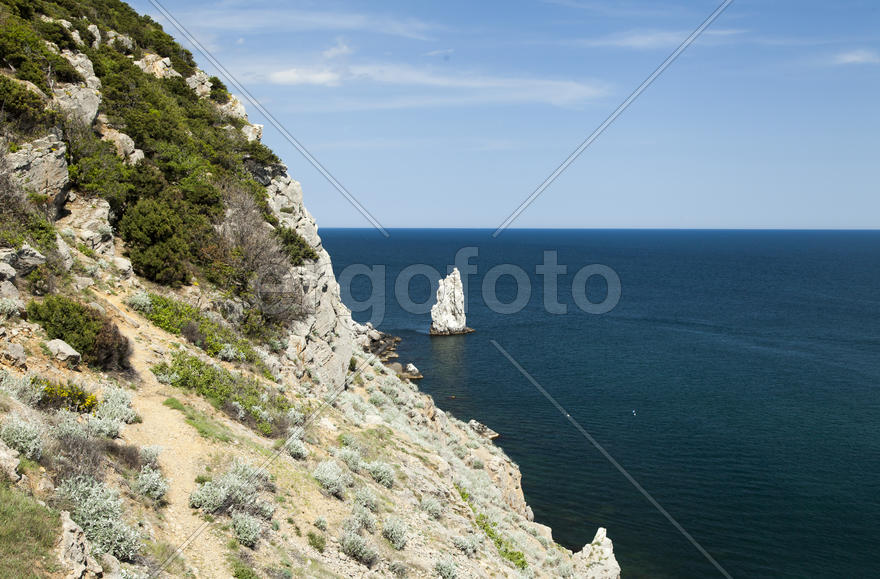 Mountains by the sea in beams of a bright sun