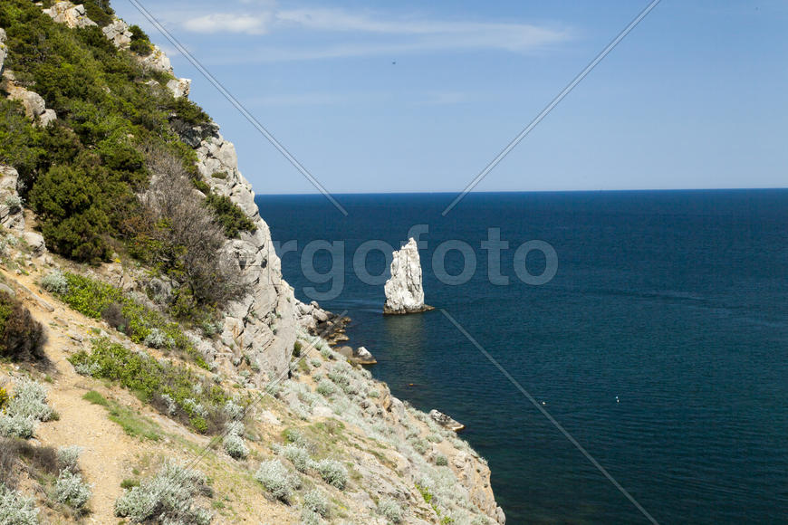 Mountains by the sea in beams of a bright sun