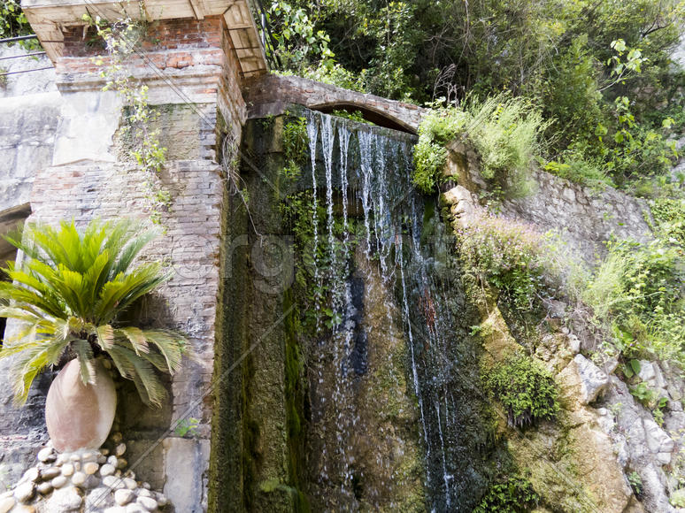 The falls in mountains flow from above and rustle
