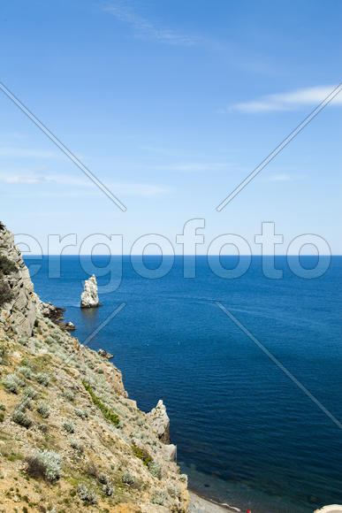 Mountains by the sea in beams of a bright sun