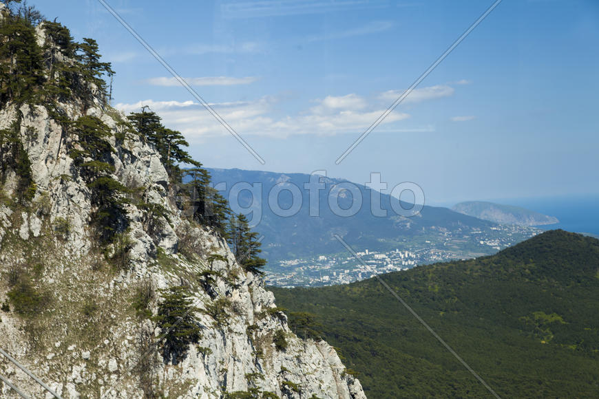 Mountains by the sea in beams of a bright sun