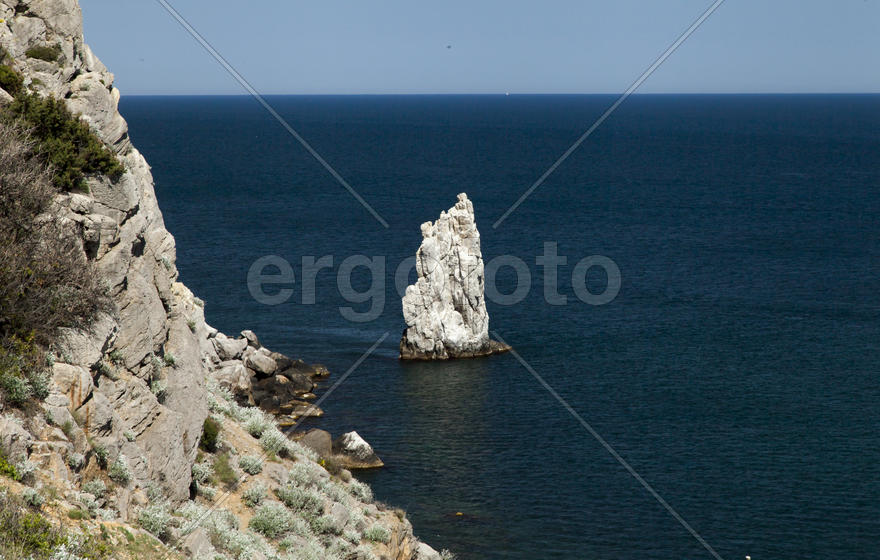 Mountains by the sea in beams of a bright sun