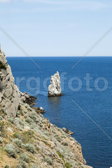 Mountains by the sea in beams of a bright sun