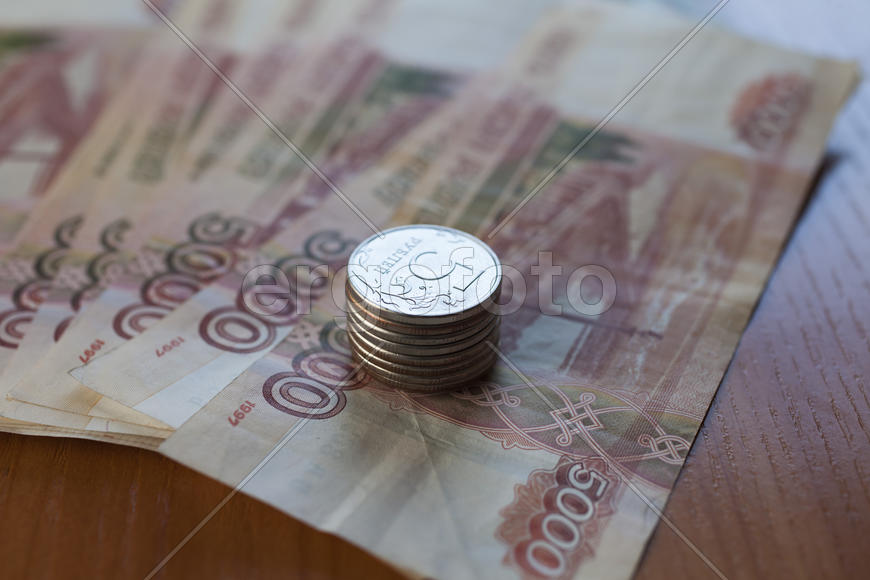 The roll of money on a table lies on pleasure to the owner