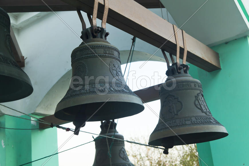 Bells on a belfry waiting for evening service and the bell ringer