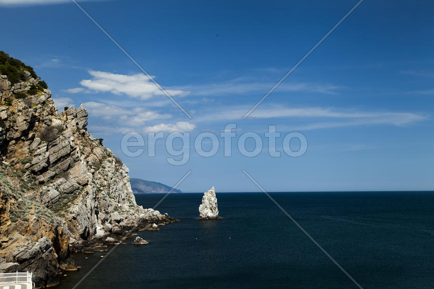 Mountains by the sea in beams of a bright sun
