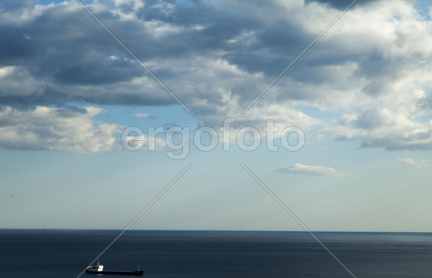 City bay with the ships in it under the blue sky and a bright sun