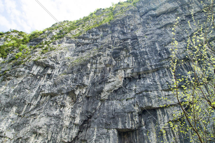 Mountains in the woods and snow are surrounded with clouds
