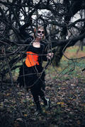 Девушка в маскарадном костюме у дерева