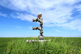 Canned oil well against the sky and field. Equipment of an oil well. Shutoff valves and service
