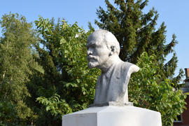 Old monument to Lenin. A concrete bust of Lenin near recreation center in the rural settlement