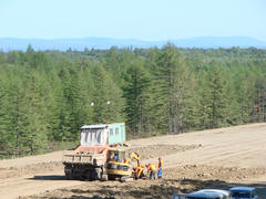 Planning of the district under construction of the pipeline. Truck and excavator