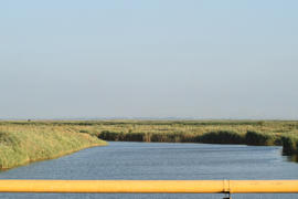 The gas pipeline through the small river. Equipment of oil and gas crafts