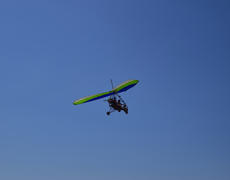 Trike, flying in the sky with two people. Extreme Entertainment travelers.