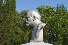 Old monument to Lenin. A concrete bust of Lenin near recreation center in the rural settlement