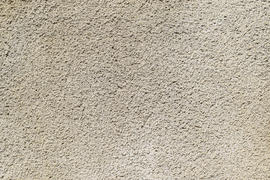 Texture of a wall from the made foam plaster. Types of external coverings of the building