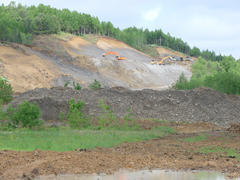Excavation of a pit. Production of gray crushed stone for road powder