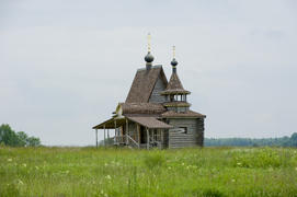 Lonely wooden chapel in the field