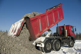 Red truck unloads rubble oilfield