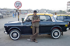 A young taxi driver near his car in Mumbai