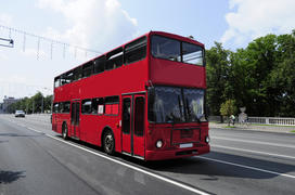 Red double decker bus traveling on the main street of Minsk