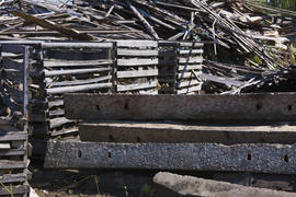 A pile of old boards in an abandoned factory in the industrial zone