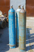 Old rusty oxygen cylinders in an abandoned factory in the industrial zone