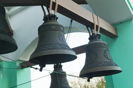 Bells on a belfry waiting for evening service and the bell ringer