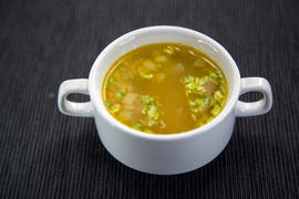 Tasty hot broth with meat and green onions